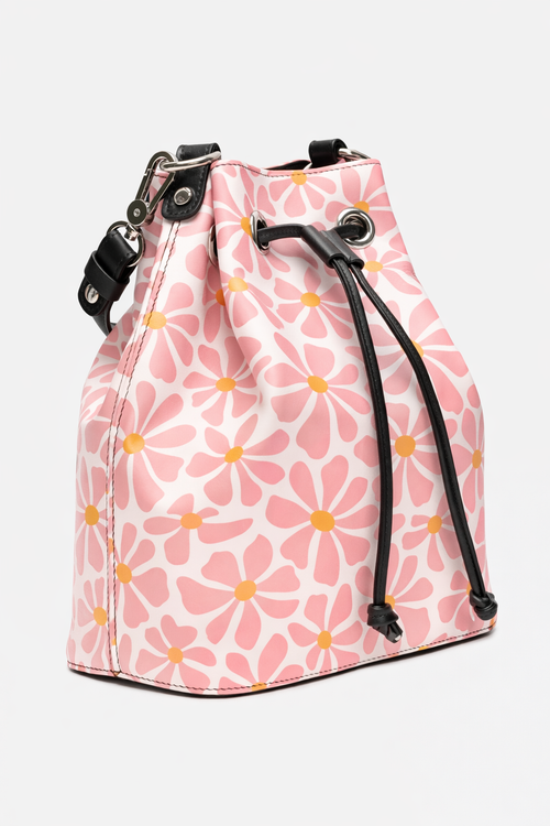 Pink drawstring bag with floral pattern on a light gray background